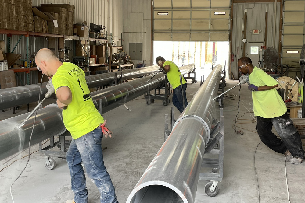 Trident workers wearing PPE working on composite pole construction